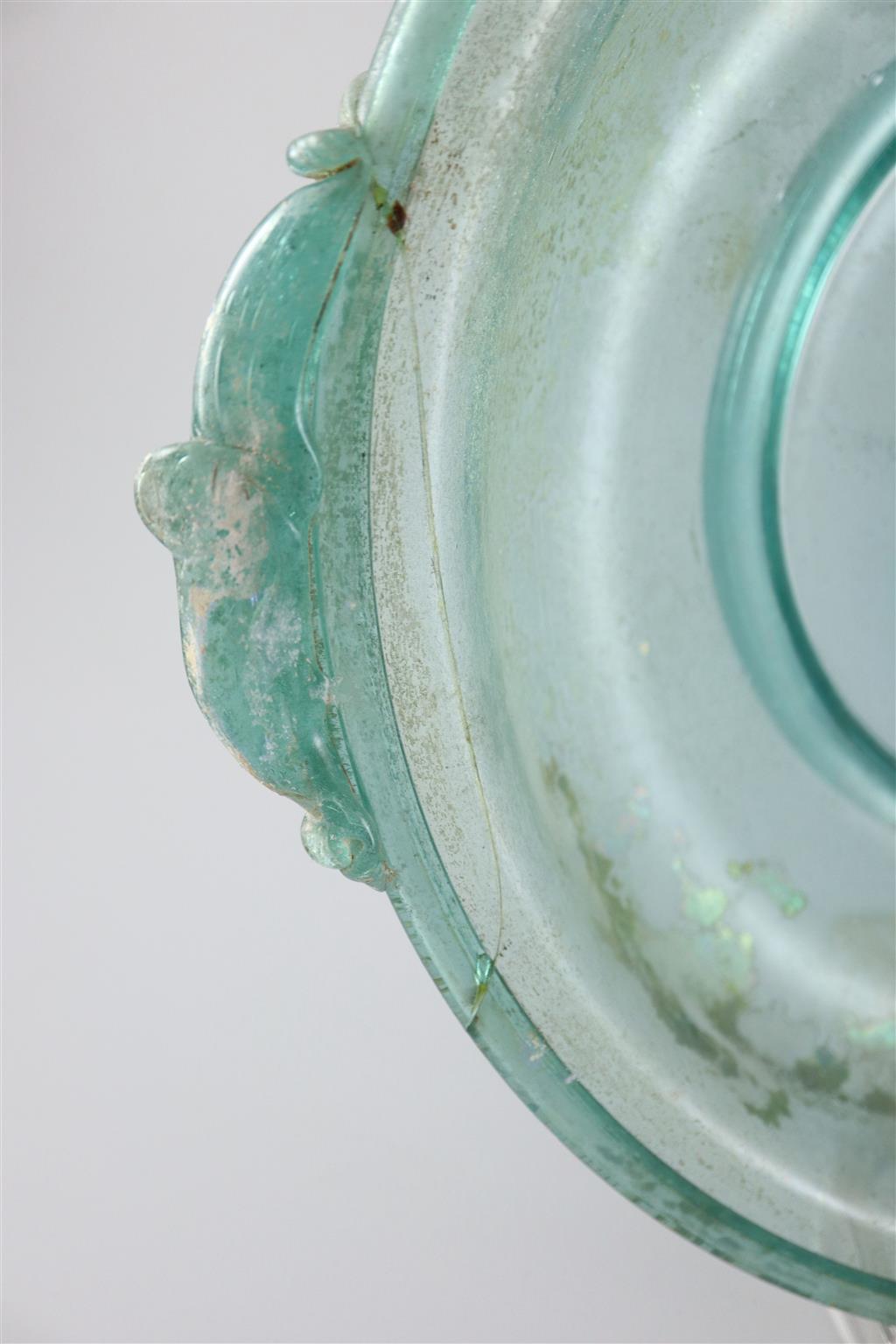 A Roman green glass dish, 1st/2nd century AD, 33cm across